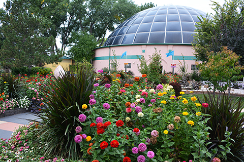 Image of the Sky Dome from the outside surrounded by beautiful gardens.